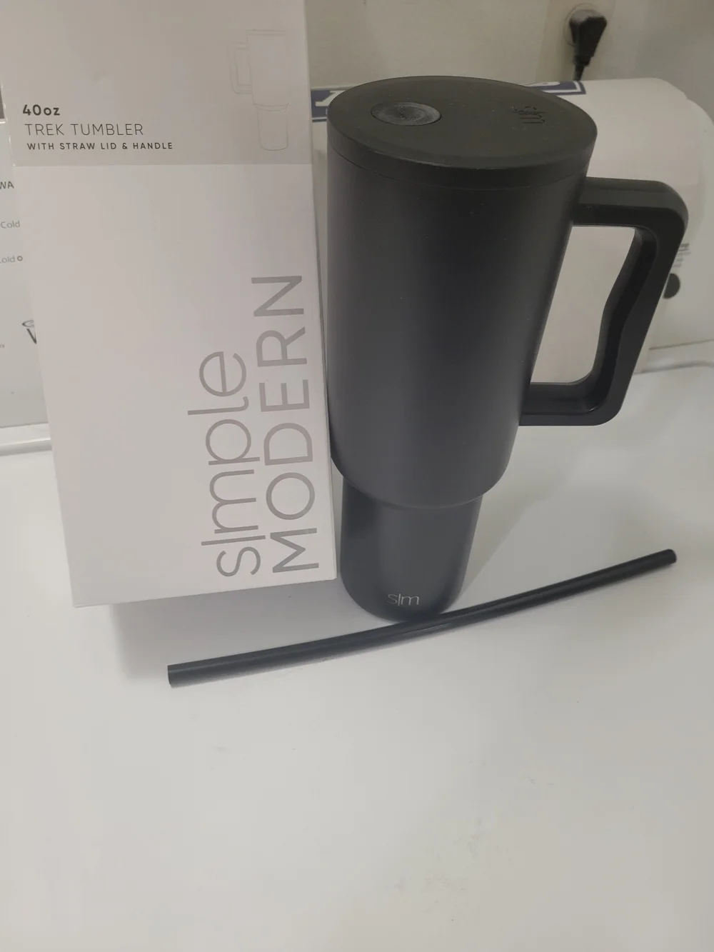 The 40 oz Trek Tumbler with Handle and Straw Lid is a reusable insulated tumbler